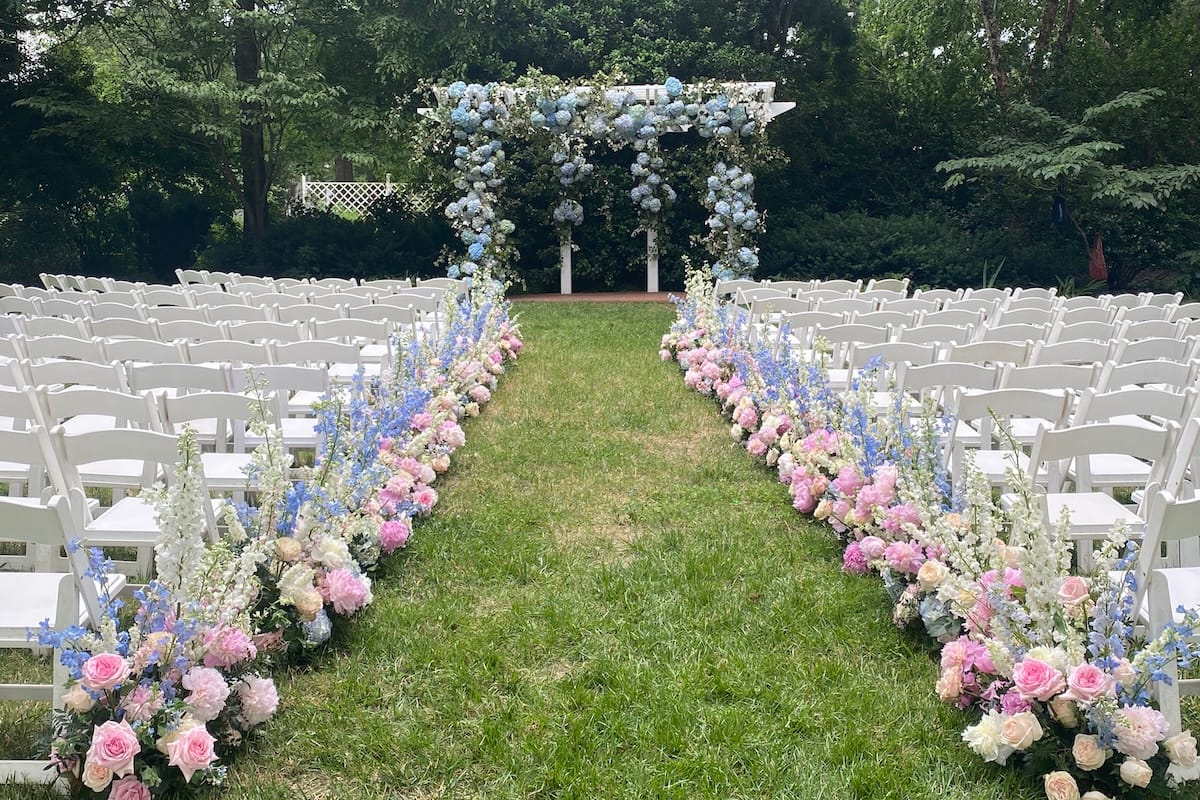Wedding ceremony with floral aisle decorations at Fearrington Village