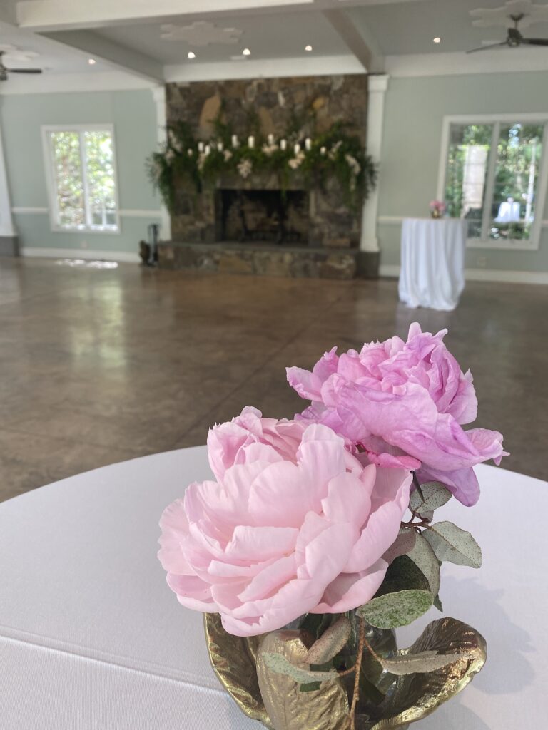 Close-up of a romantic pink and blush bridal bouquet with garden roses and trailing ribbon