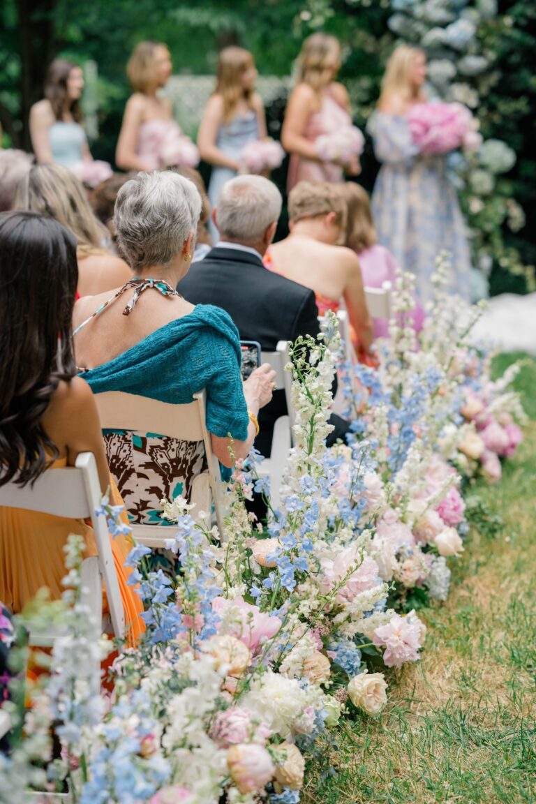 Close-up of a ceremony floral arch with blush roses, white hydrangea and draping greenery