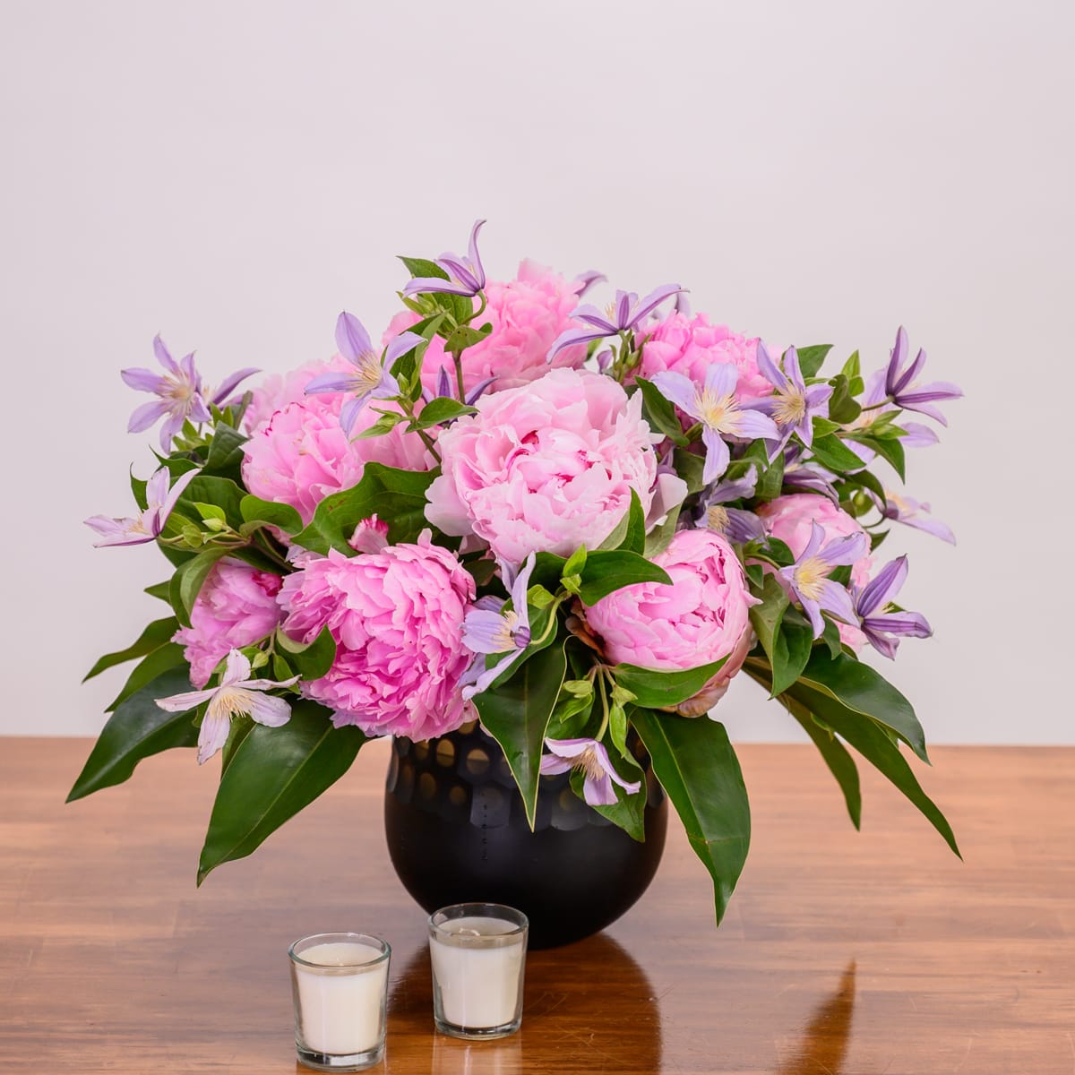 Hand-arranged peony and clematis flowers Hidden Door Floral Studio
