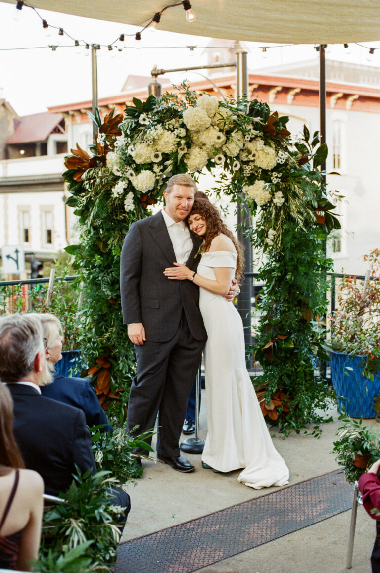 Leah and Josh portrait photo with lush green foliage background