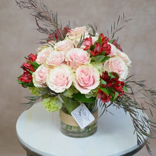 Lush pink roses and ranunculus hand arranged by a local Raleigh florist showing the difference from mass-produced online flowers - local florist vs online