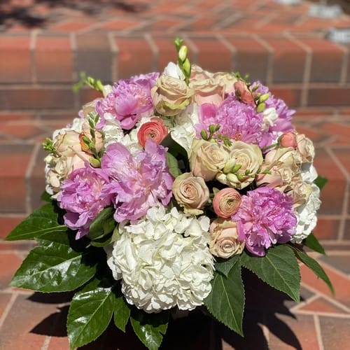 Lush pink roses and green hydrangea in a generous arrangement for same-day flower delivery in Cary NC